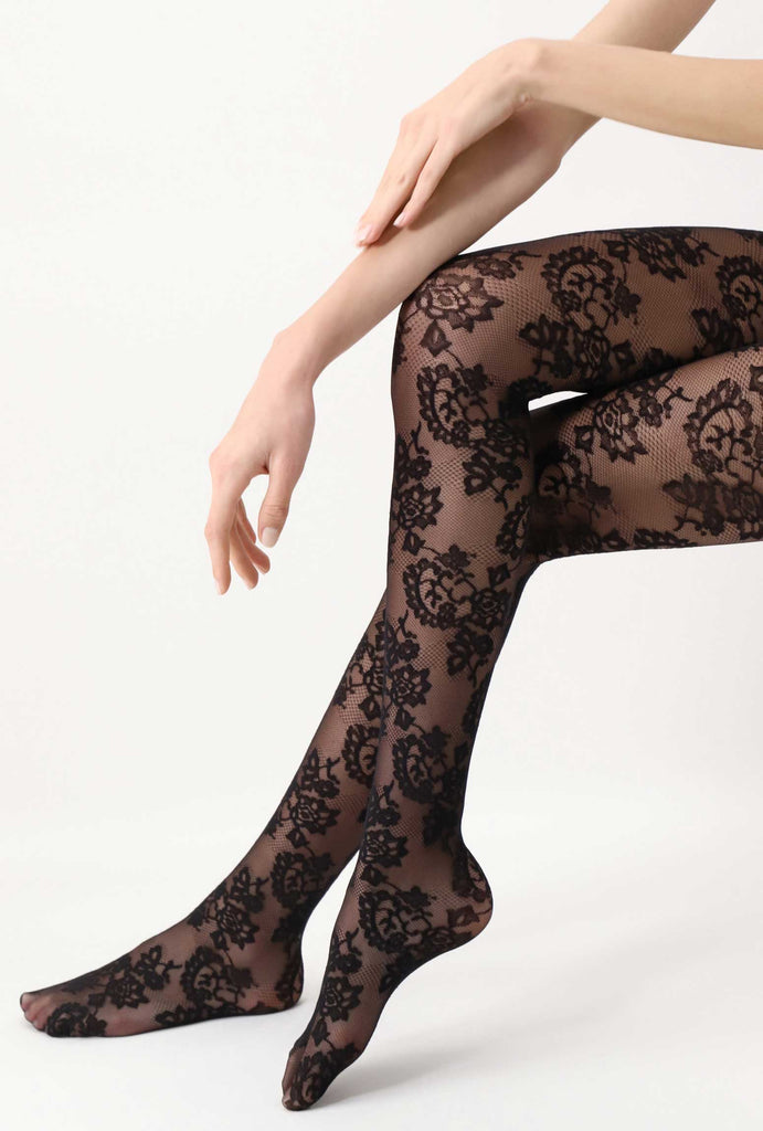 Side view of lady's lower legs in black fine lace tights.