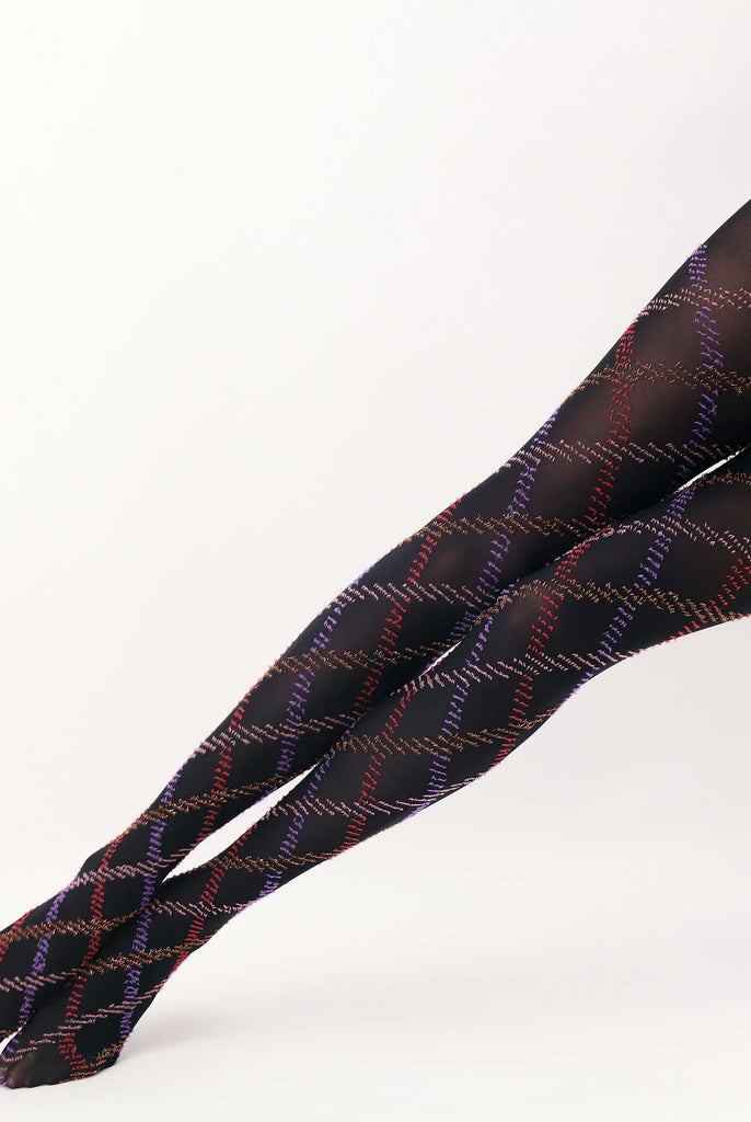 Lady's legs outstretched , wearing purple, red and gold fur thread, tartan tights.