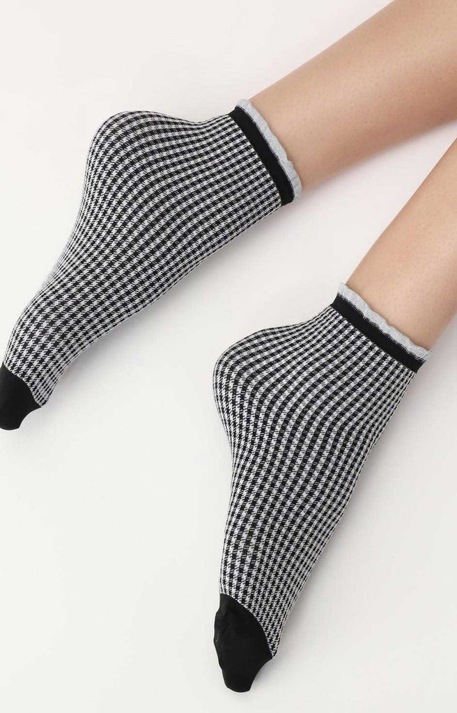 Close up of lady's feet wearing black and white gingham socks.