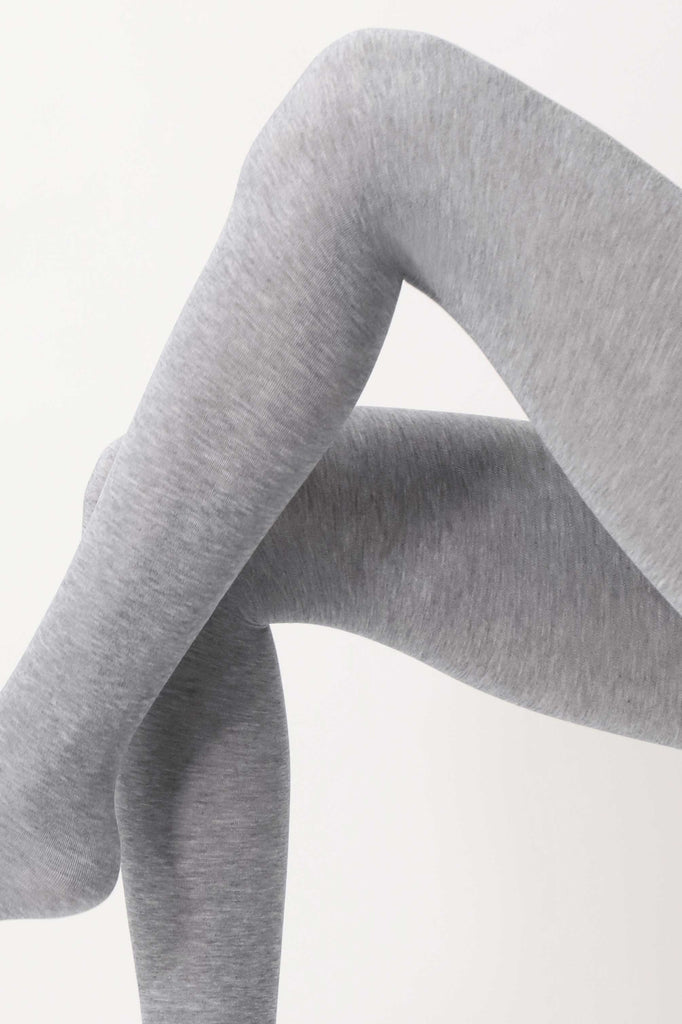 Close up of lady's legs, in light grey tights.