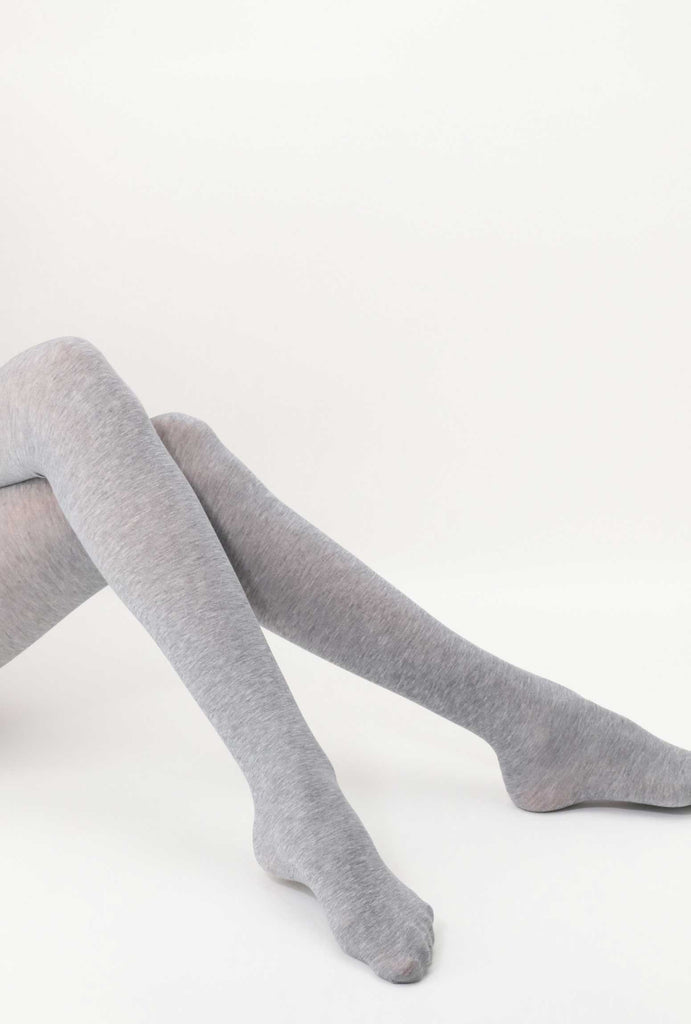Outstretched view of lady's legs, in light grey tights.