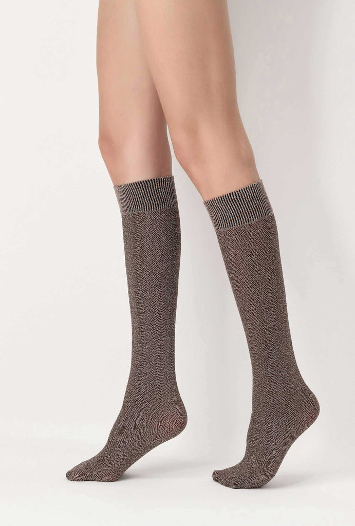 Side view of lady's lowers legs, walking and wearing brown tweed socks.