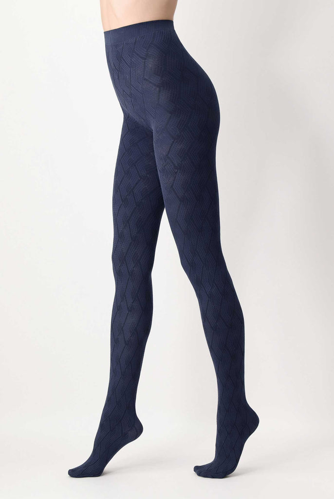 Side view of lady's legs, wearing blue and black jacquard patterned tights.