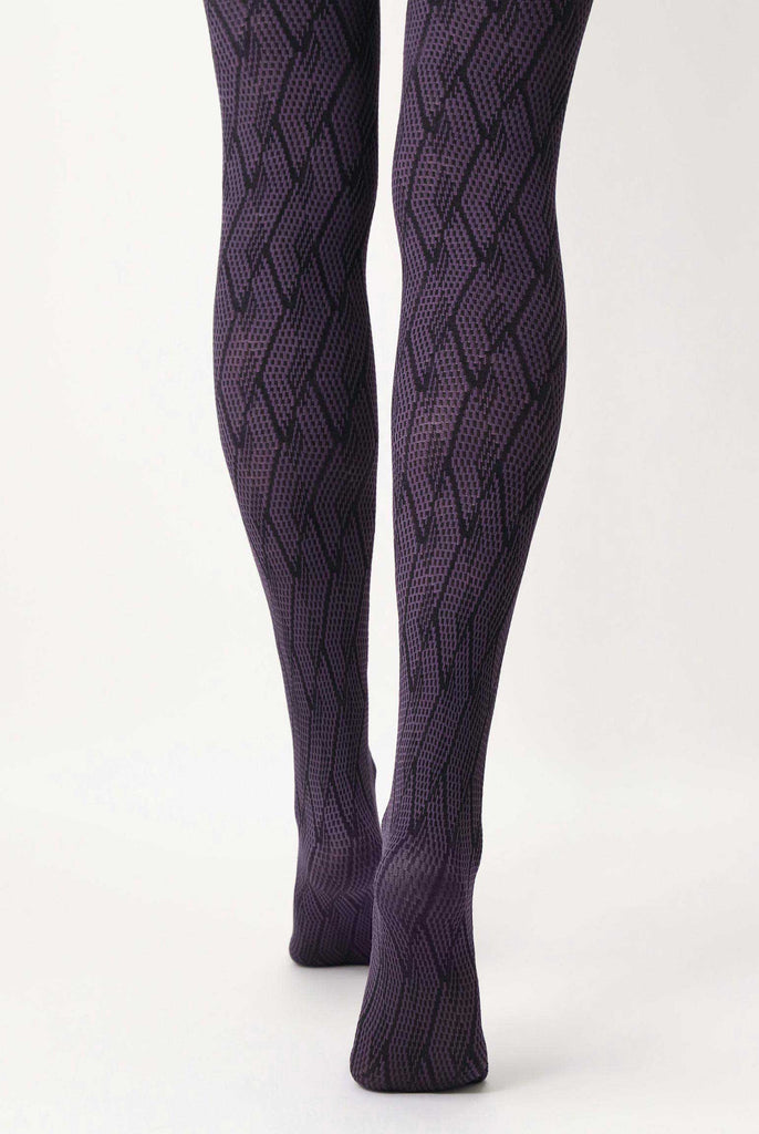 Back view of lady's lower legs wearing purple and black jacquard pattern tights.