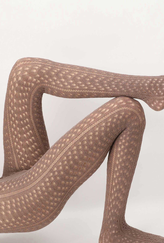 Close up of lady's legs wearing open knit toffee coloured tights.