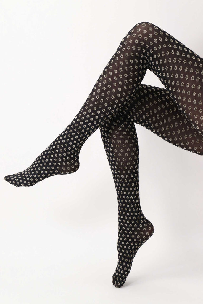 Side view of lady's legs  wearing black and grey floral tights.