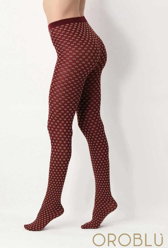 Side view of lady's legs, wearing red floral pattern tights.