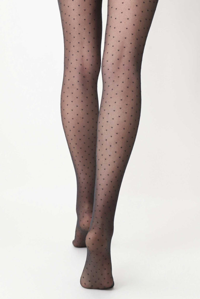 Back view of lady's legs wearing black, sheer, polka dot tights.