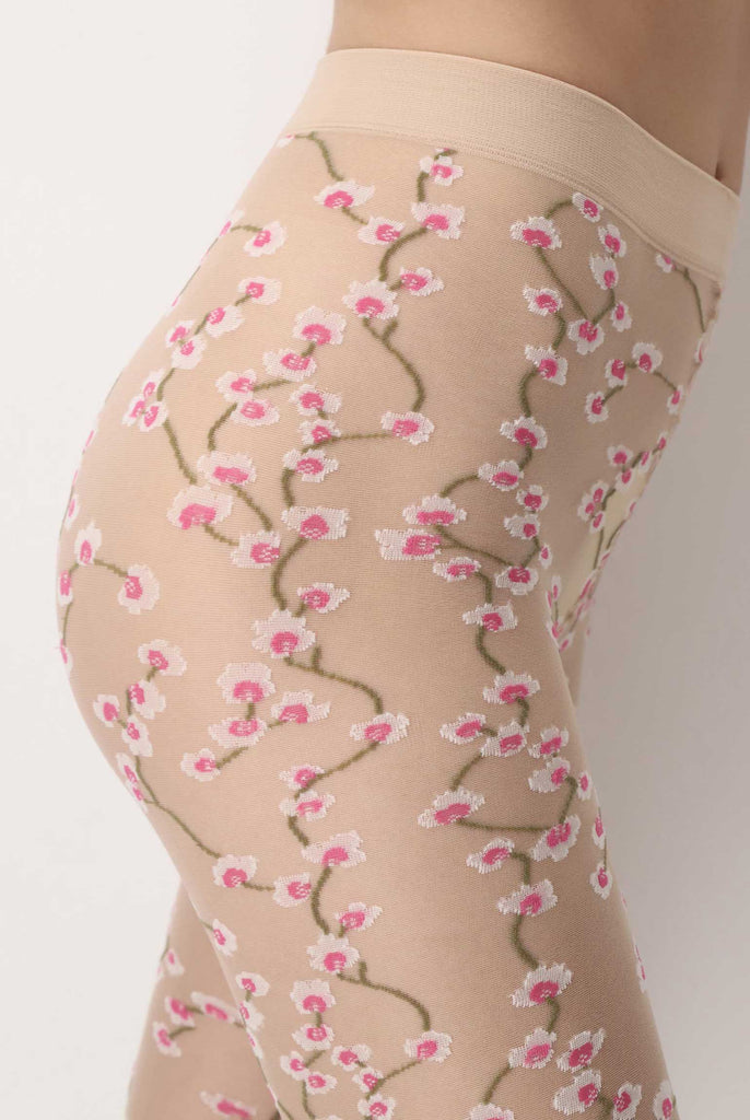 side view of lady's abdomen wearing nude, sheer floral tights.