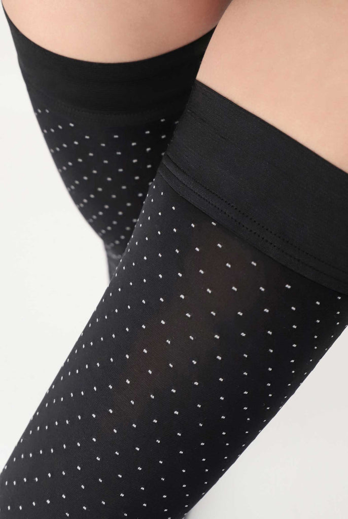 Close up of band on lady's black and white polka dot stay up stay ups 