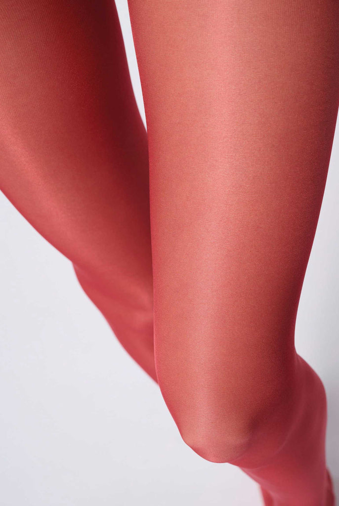 Close up of lady's upper thighs, in red tights.