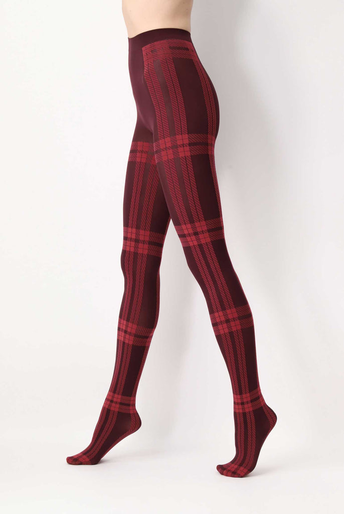 Side view of lady's legs in walking stance, wearing red plaid tights.