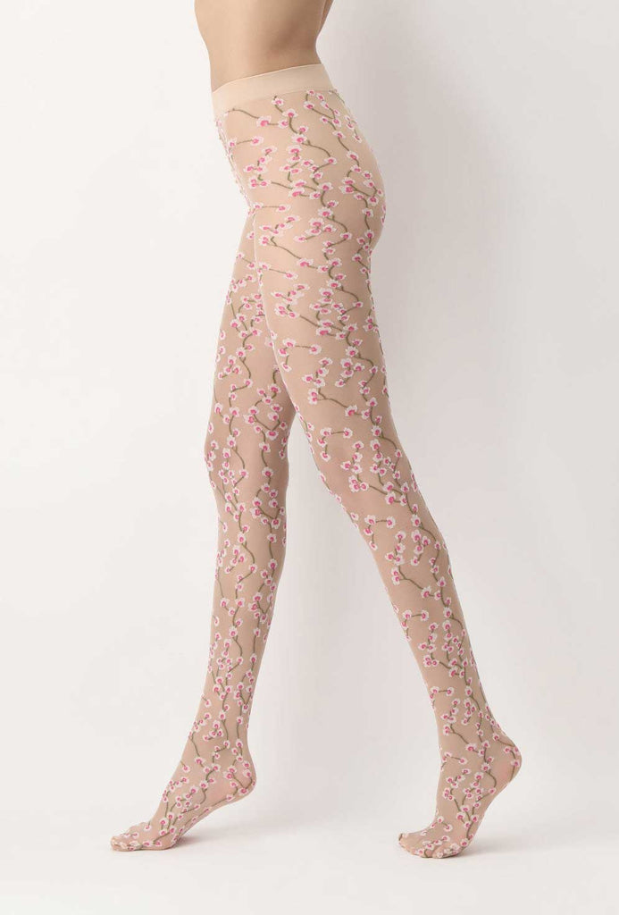 Side view of lady's legs walking in sheer nude tights with floral pattern.