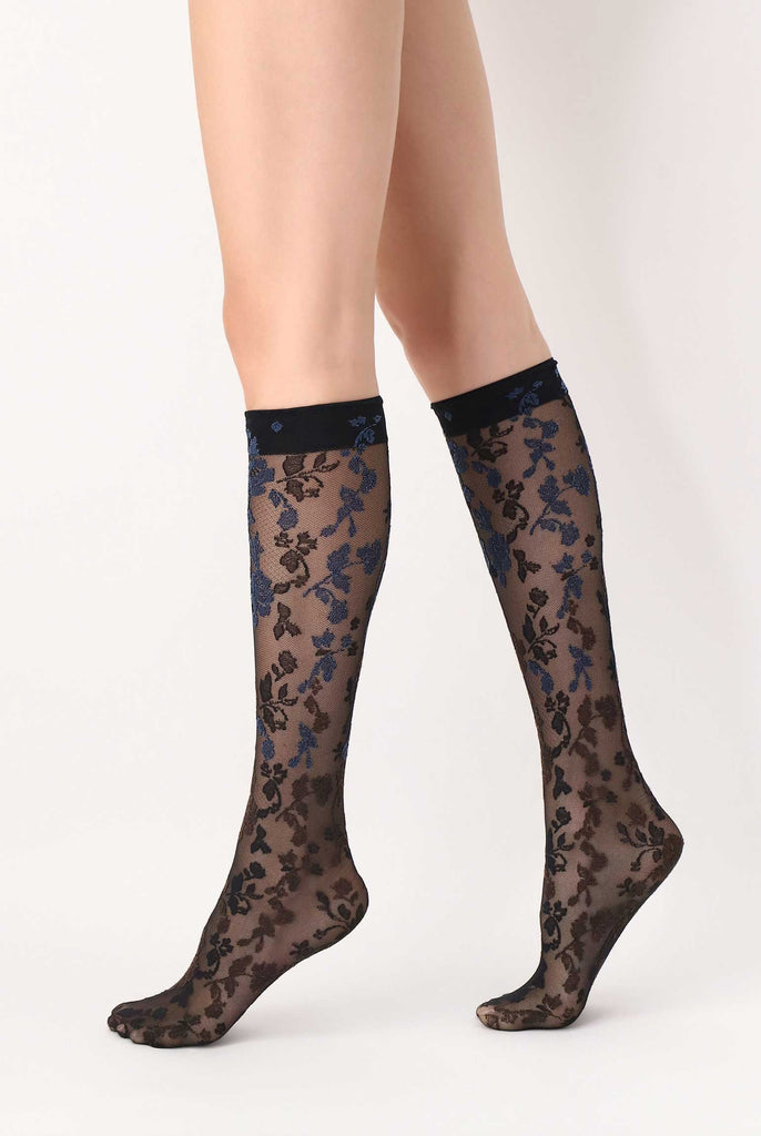 Side view of lady's legs walking in brown/blue floral, sheer knee highs.