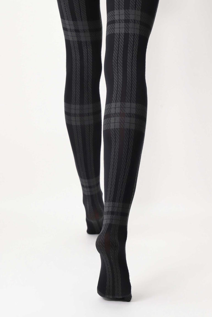 Back view of lady's legs, walking and wearing grey plaid tights.