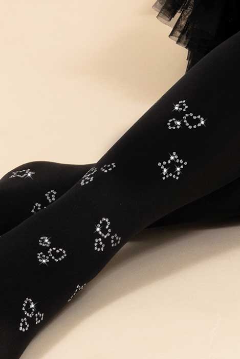 Close up of girl's lower legs in black tights with silver sequins.