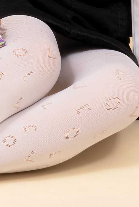 Close up of girl's lower legs in white tights that are scripted with word love.
