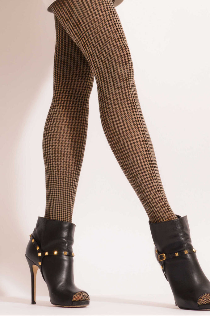 Close up of lady's legs in side walking stance, in black ankle boots and camel and black pattern tights.