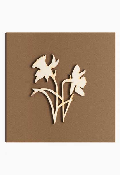 Wooden cut out daffodils on brown card.