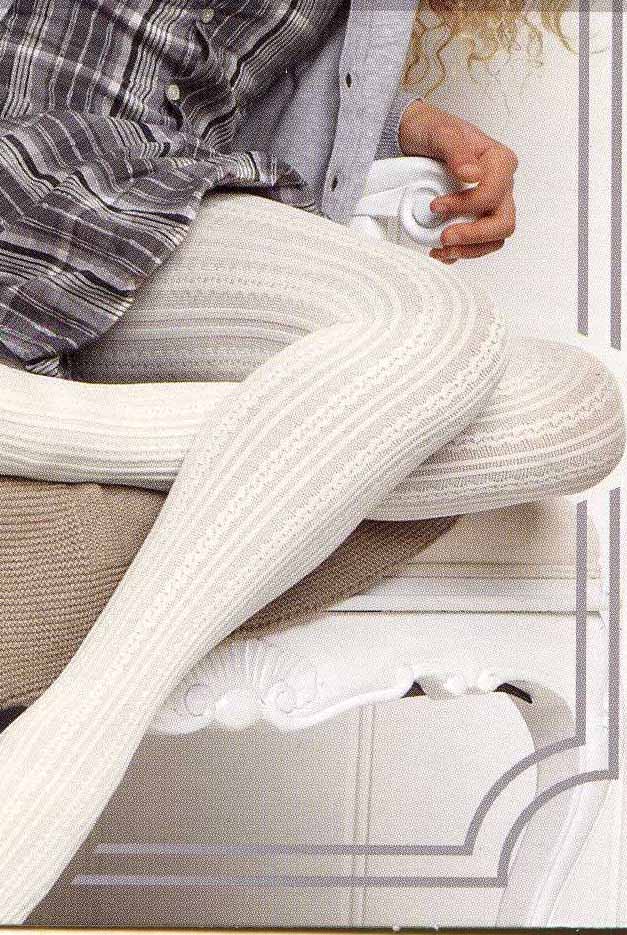 Close up of a girl's legs wearing white cable knit tights.