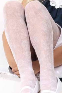 Close up of girls legs wearing white floral lace tights.