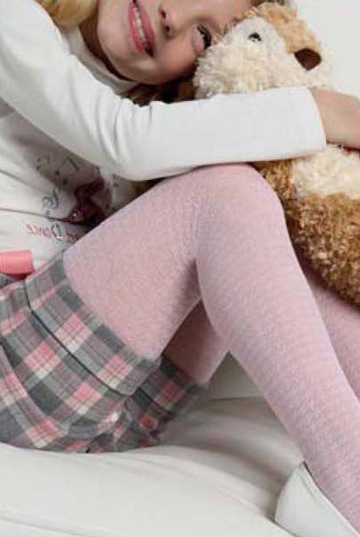 Close up of girls leg ,pulled up with arm resting on her leg, wearing cheque shorts and pink tights with a houndstooth pattern.