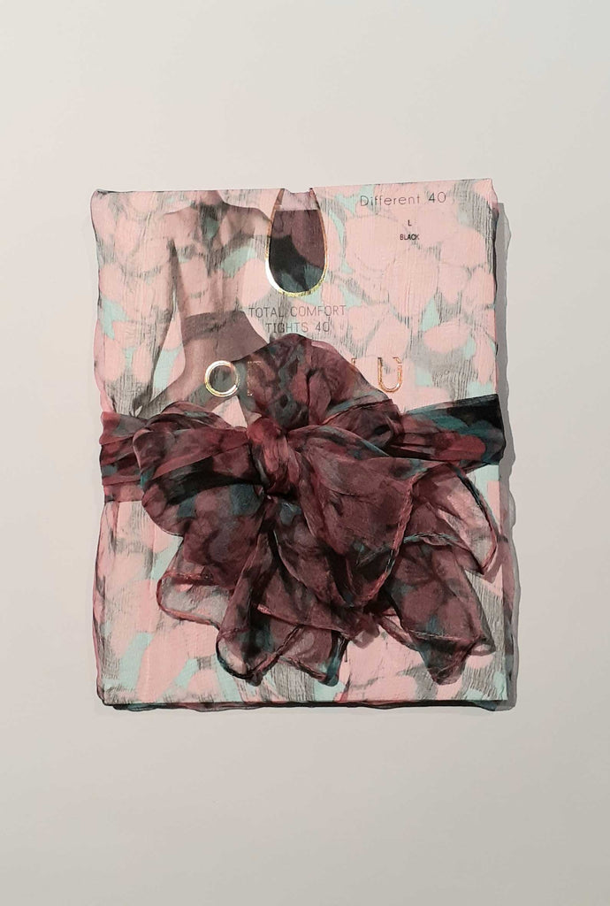 Pink and green, sheer scarf used as gift wrap.