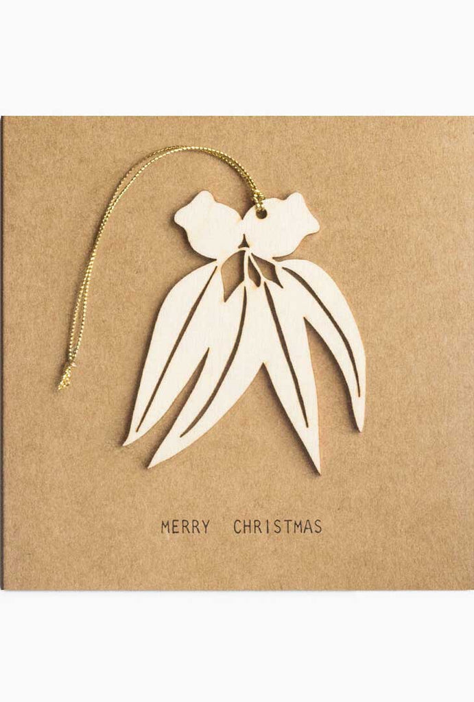 Kraft Christmas greeting card with gum nuts hanging decoration.