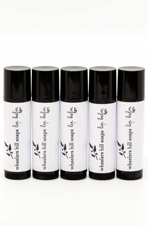 Five black and white tubes of lip balm.