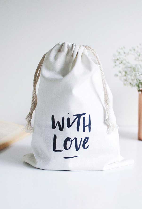Canvas white bag with the phrase, with love, written on the front.