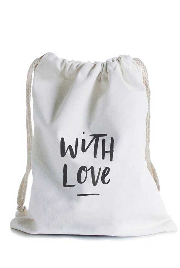 White canvas bag with drawstrings and words, with love, across the front.