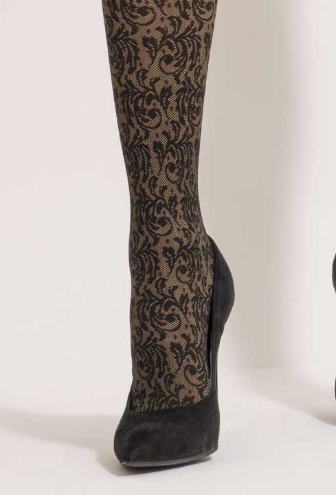 Close up of lady's foot in black velvet heels and black and camel floral tights.