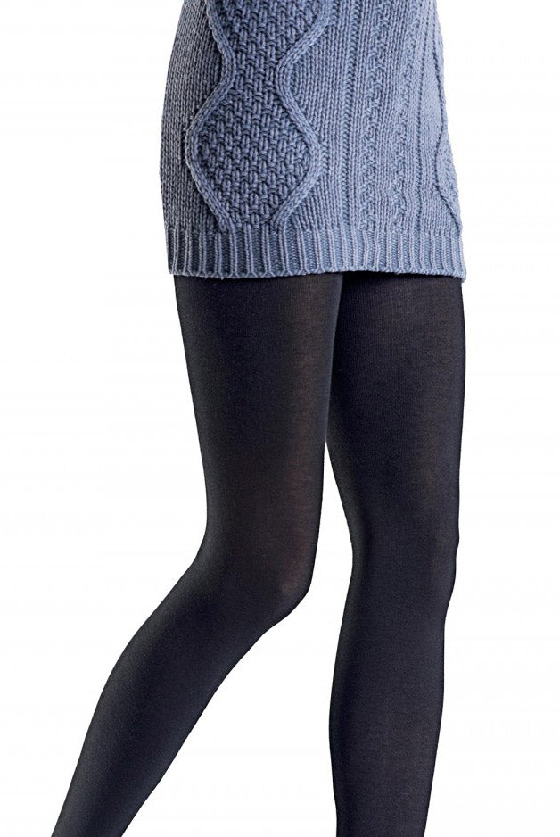 Close up of lady's upper thighs and kees in black tights and cable knit grey dress.