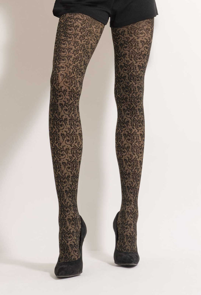 Lady's legs in black and camel damask pattern tights and black heels.