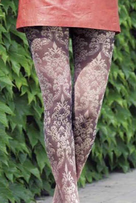 Close up of lady's upper legs in white damask print tights.