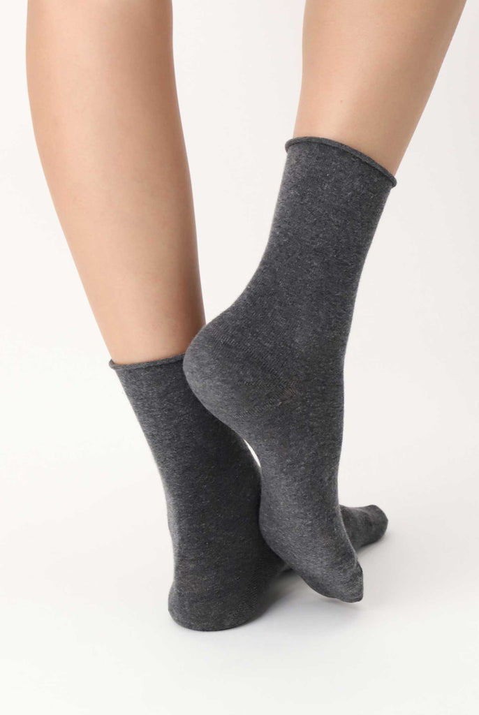 Back view of lady's feet in grey socks.