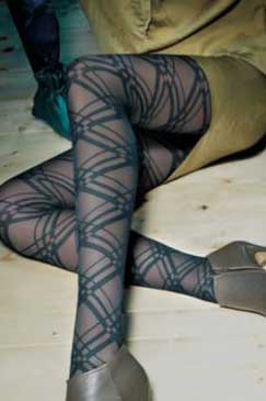 Close up of lady's lower legs, outstretched and crossed in green geometric tights.