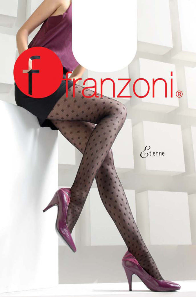 Lady's legs resting against a white wall in black diamond mesh tights and glossy pink heels.