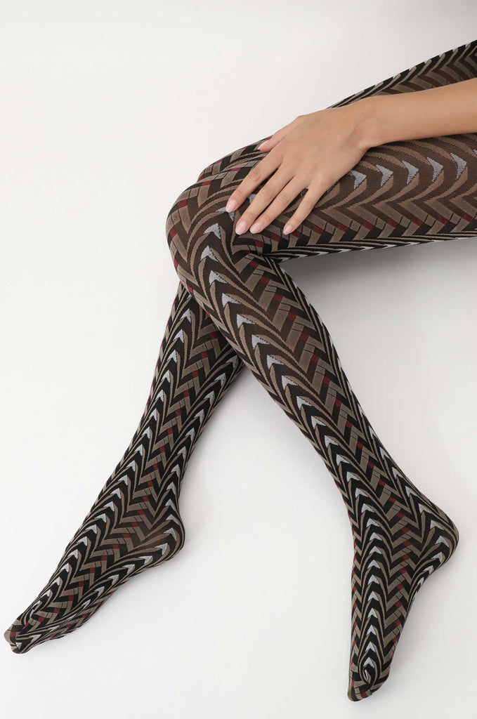 Lady's legs in outstretched kicking position in  black and brown pattern tights.