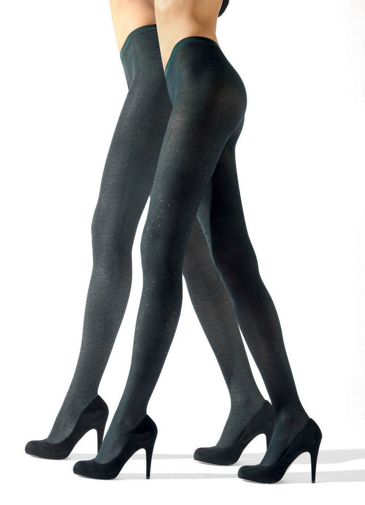 Side view of two ladies legs walking in green tights and black  heels.