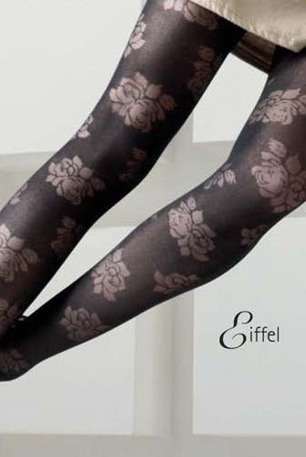 Close up of chocolate brown tights with repeating flower pattern on a lady's legs.
