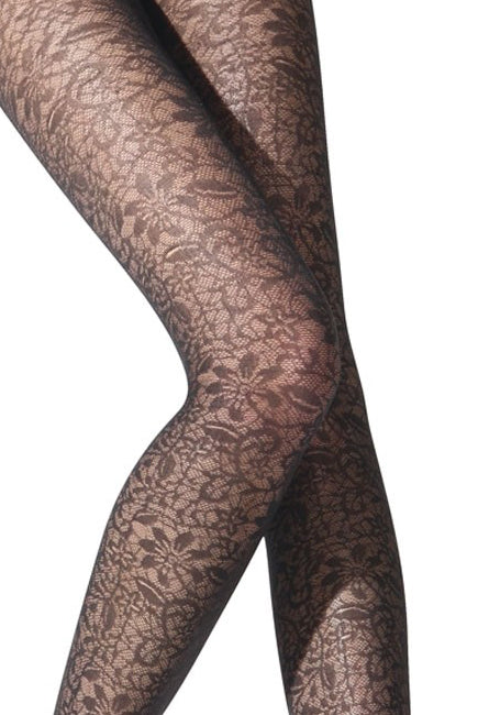 Close up of lady's knees and thighs wearing black floral tights.