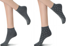 Ladies feet wearing light grey with silver pattern ankle socks.