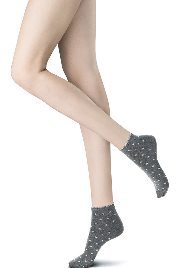 Lady's feet in light grey short socks with tiny silvery flowers.