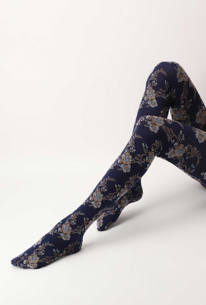 Lady's legs outstretched, wearing blue, floral tights.