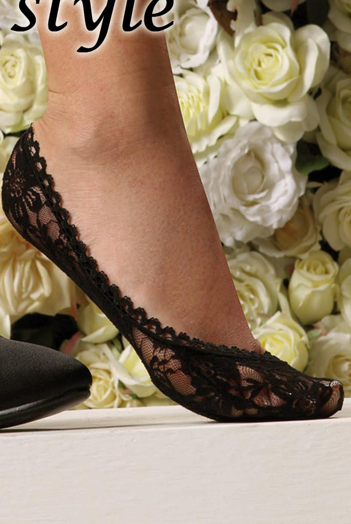 Lady's foot wearing black lace footless.