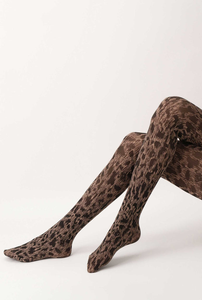 Lady's legs, crossed, wearing leopard print tights