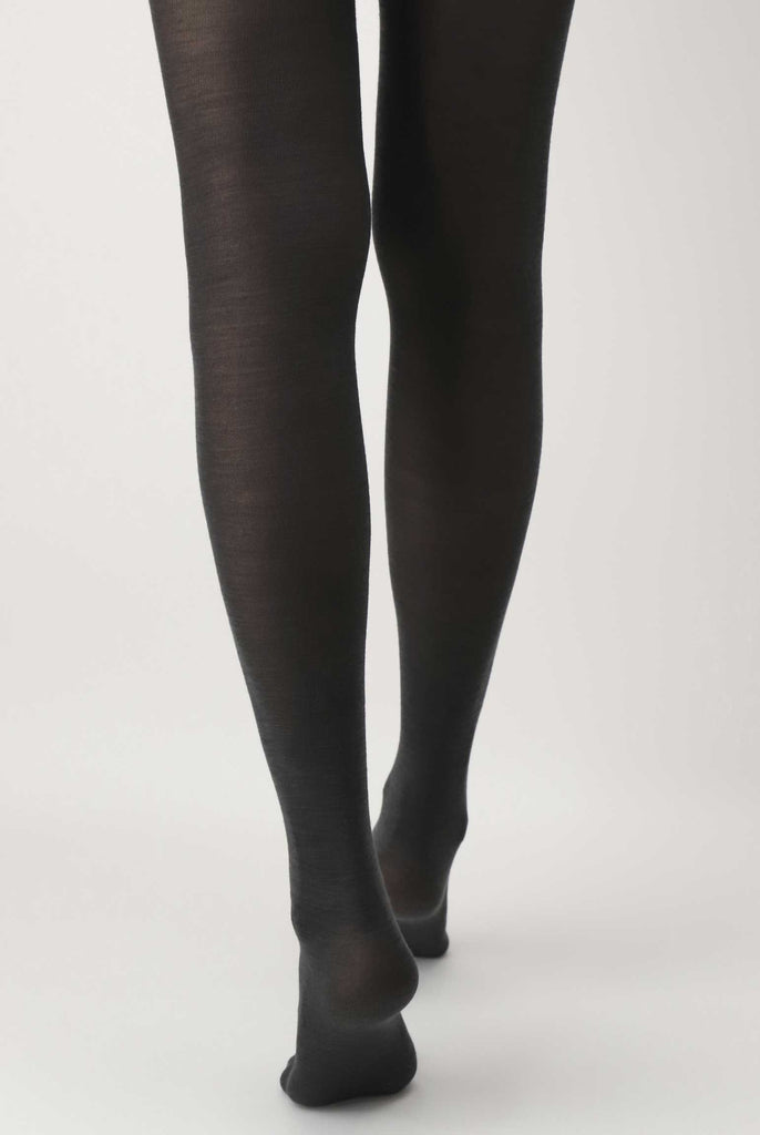Back view of lady's lower legs, wearing dark grey tights.