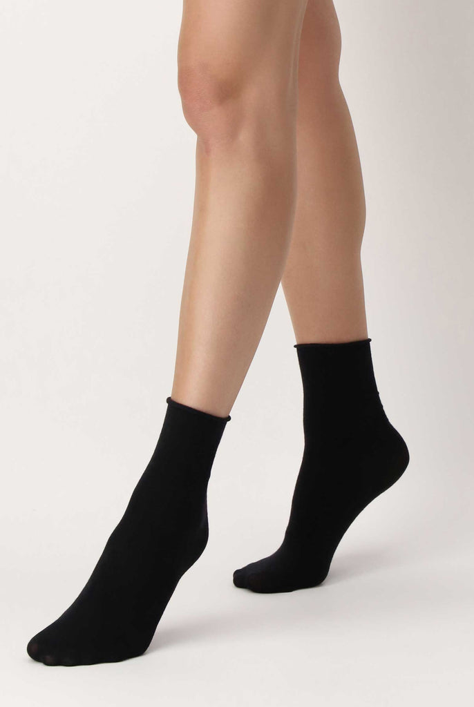 Close up of lady's feet in walking motion in black socks.