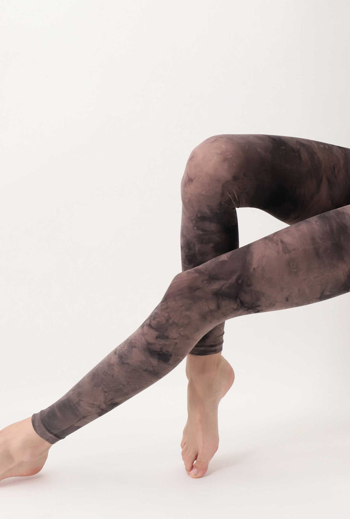 Outstretched lady's legs in brown tie-dye footless tights.  